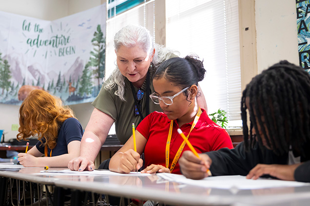 teacher helping a student